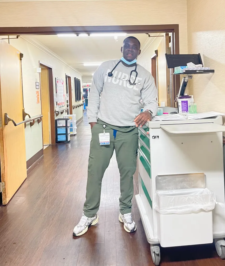 Nurse Lartey Solomon in a hospital hallway.
