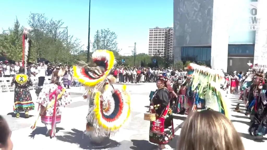 Native American dance show with performers in elaborate, colorful regalia.