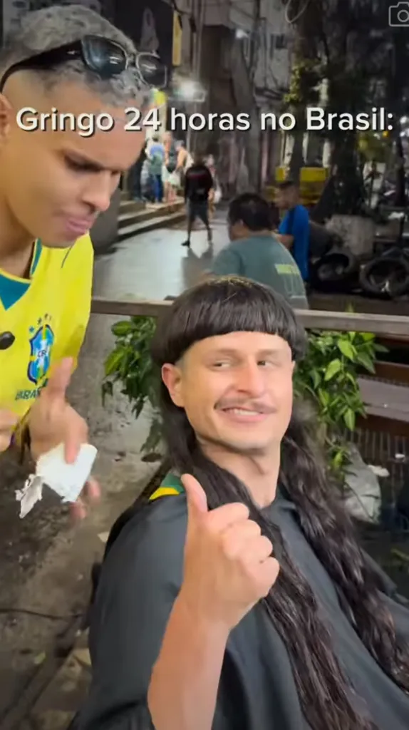 Oliver Tree getting a haircut and giving a thumbs up in Brazil.