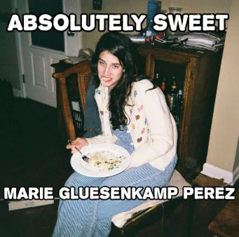 Marie Gluesenkamp Perez with pasta hanging from her mouth, with text 