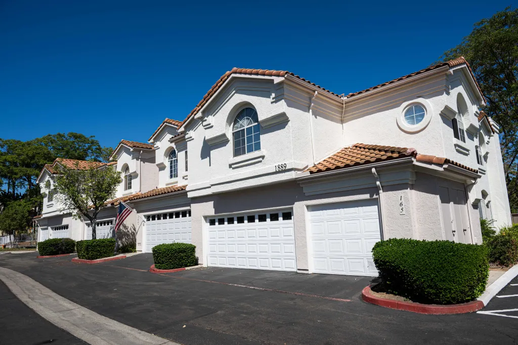 The exterior of Chris and Amy Cooke's home in San Marcos, CA, featuring a prominent American Flag.