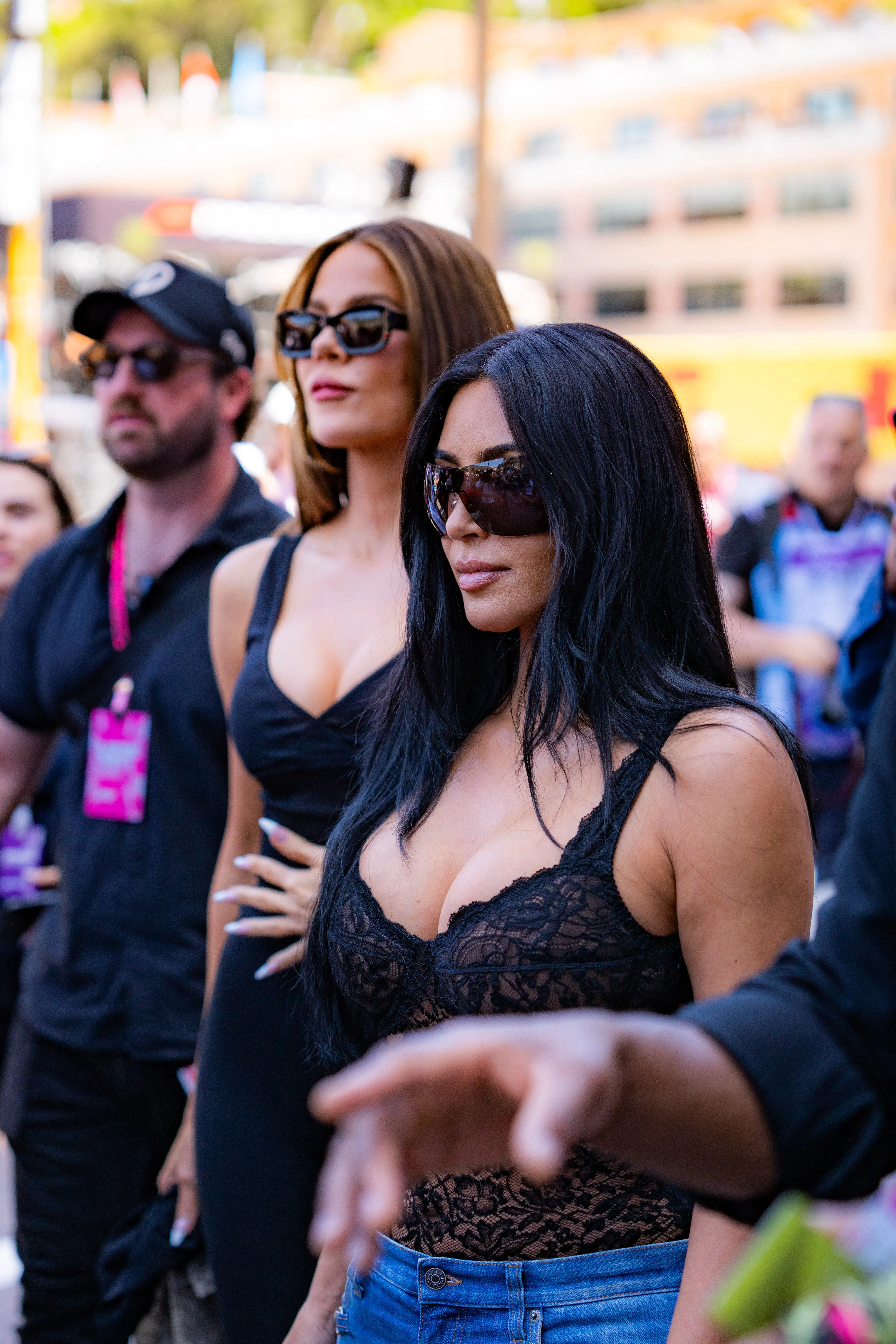 Kim and Khloe Kardashian, both wearing sunglasses, attend the Louis Vuitton Monaco Grand Prix.