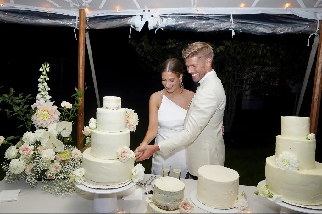 Amanda Batula and Kyle Cooke cutting their wedding cake.