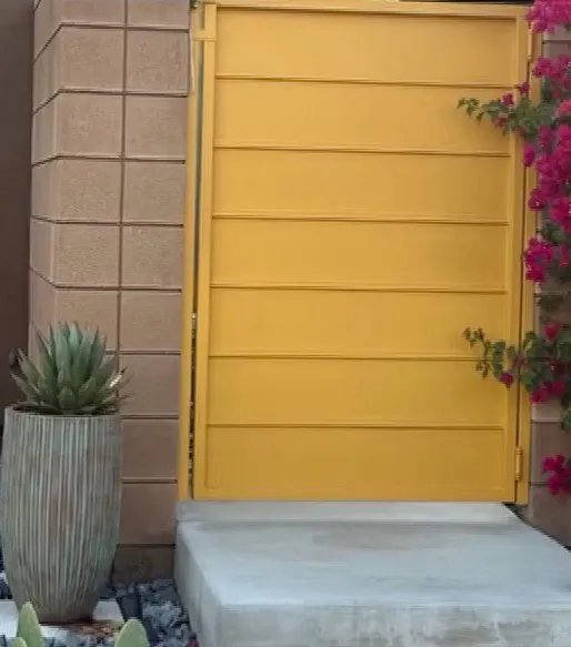 Yellow gate with horizontal panels.