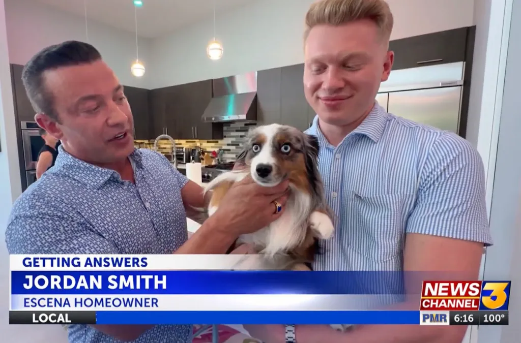 Jordan Smith and another man holding a dog, with a news chyron at the bottom.