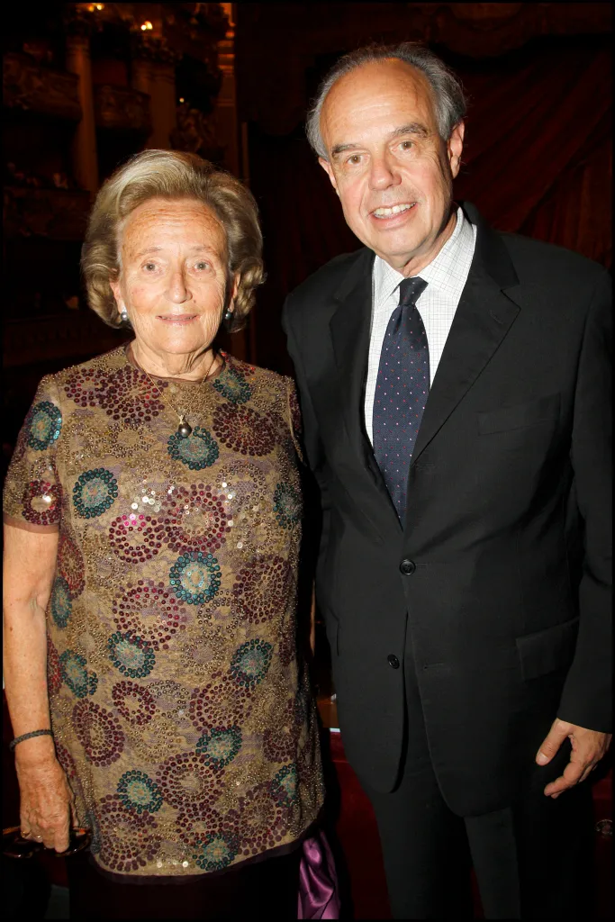 Bernadette Chirac, former First Lady of France, pictured alongside a man in a black suit.
