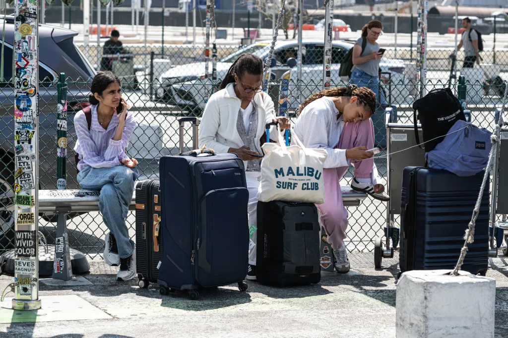 Passengers at LAX airport await their rideshare.