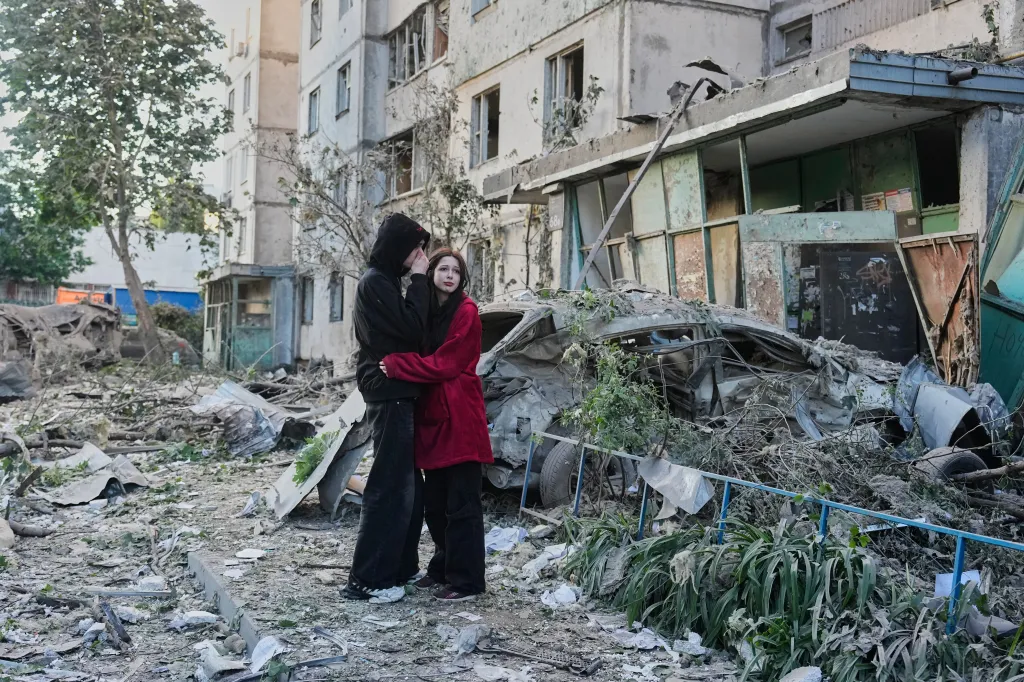 People react as they look at the site of Russian missile strike that hit a residential building in Kyiv, Ukraine, Tuesday, June 2, 2026.