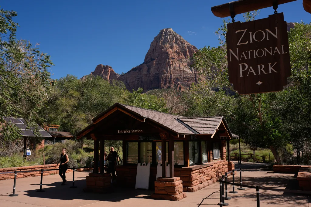 People walk past an unstaffed entrance station at Zion National Park near Springdale, Utah.