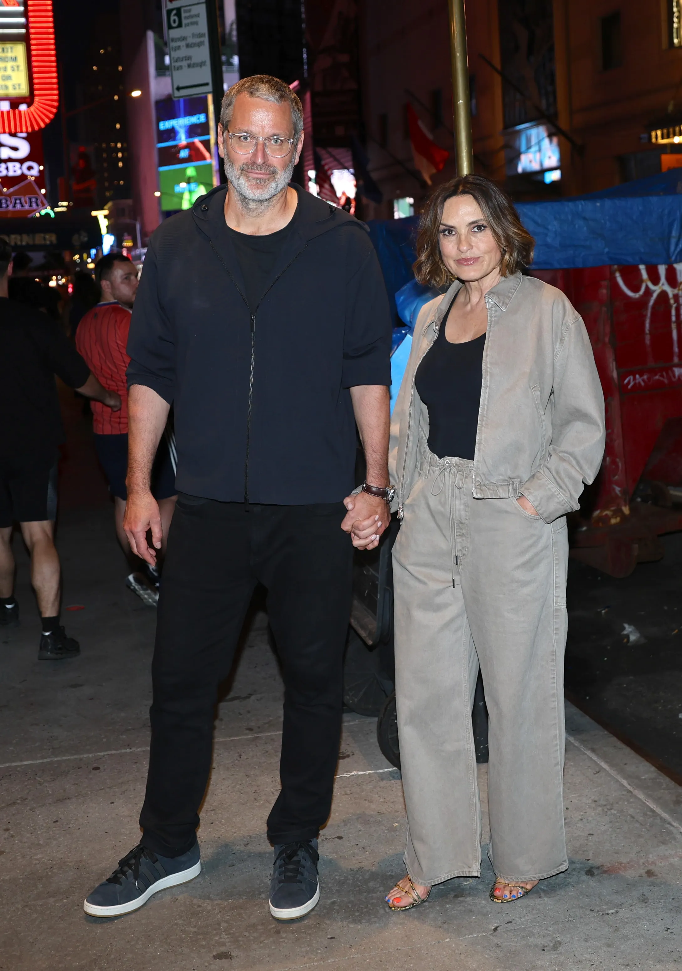 Peter Hermann and Mariska Hargitay holding hands after her Broadway show.