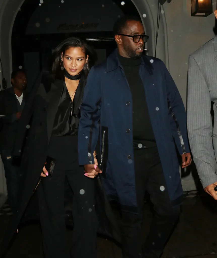 Sean Combs and Cassie Ventura walk together.