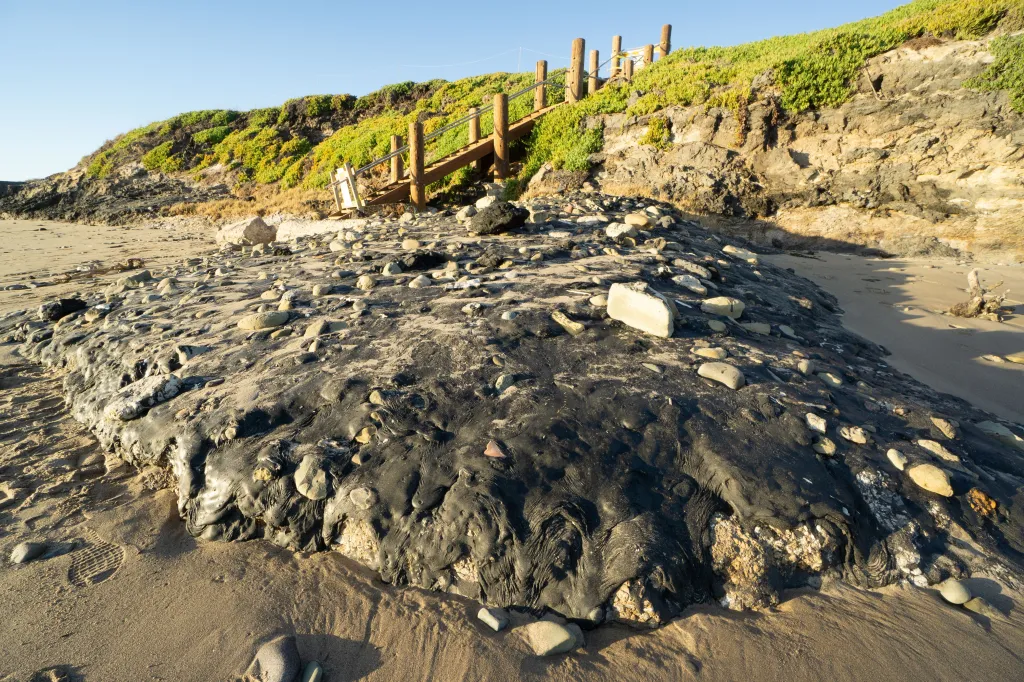 Black oil seeping onto a sandy beach in Carpenteria, California.