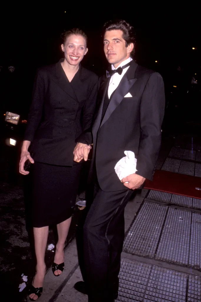 John F. Kennedy Jr. and Carolyn Bessette holding hands at night.