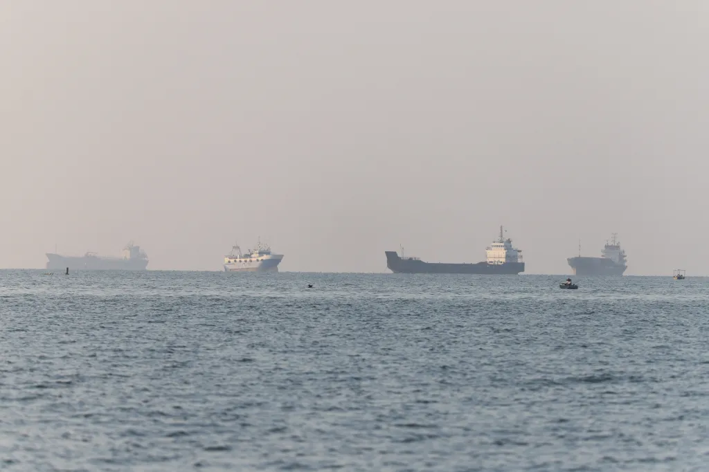 Cargo vessels and small boats in the Strait of Hormuz near Bandar Abbas.