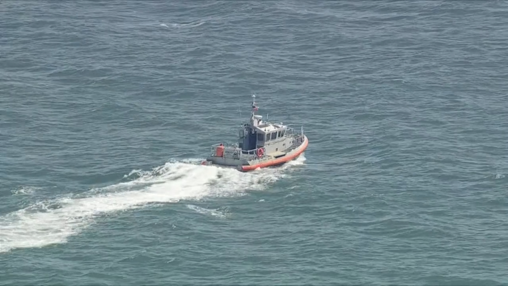 A coast guard vessel searches the ocean.
