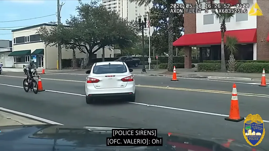 Police chase suspected drunk driver Darrell Simon as he drives into the race course at IRONMAN Jacksonville on May 16, 2026.