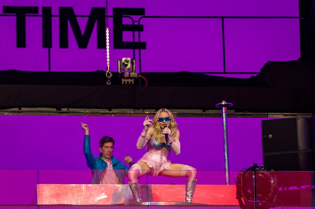 Popstar Madonna performs a pop-up concert.