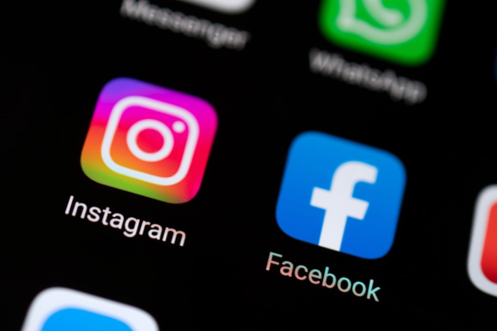 Close-up of the Instagram and Facebook app logos on a smartphone screen.