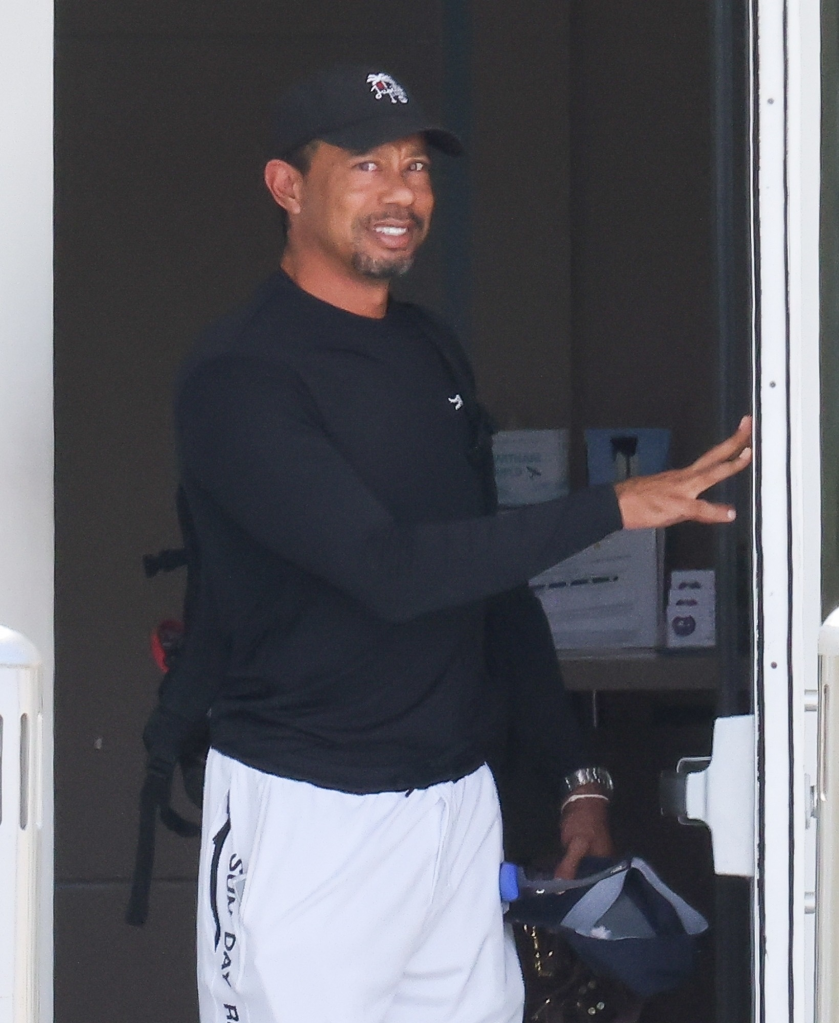 Tiger Woods exits a private airport after rehab in Switzerland.
