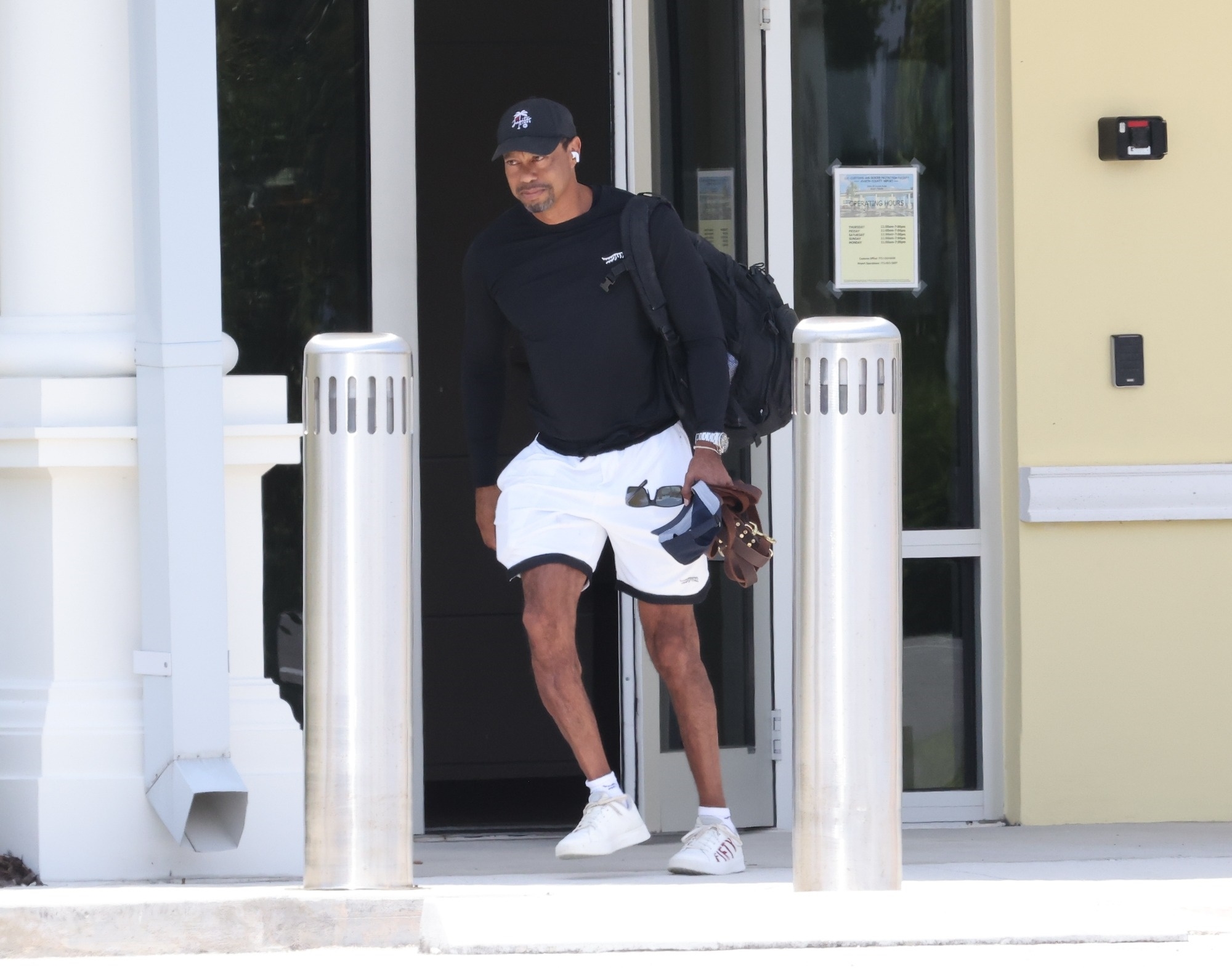 Tiger Woods walking out of a private airport in Jupiter, Florida after returning home from rehabilitation.