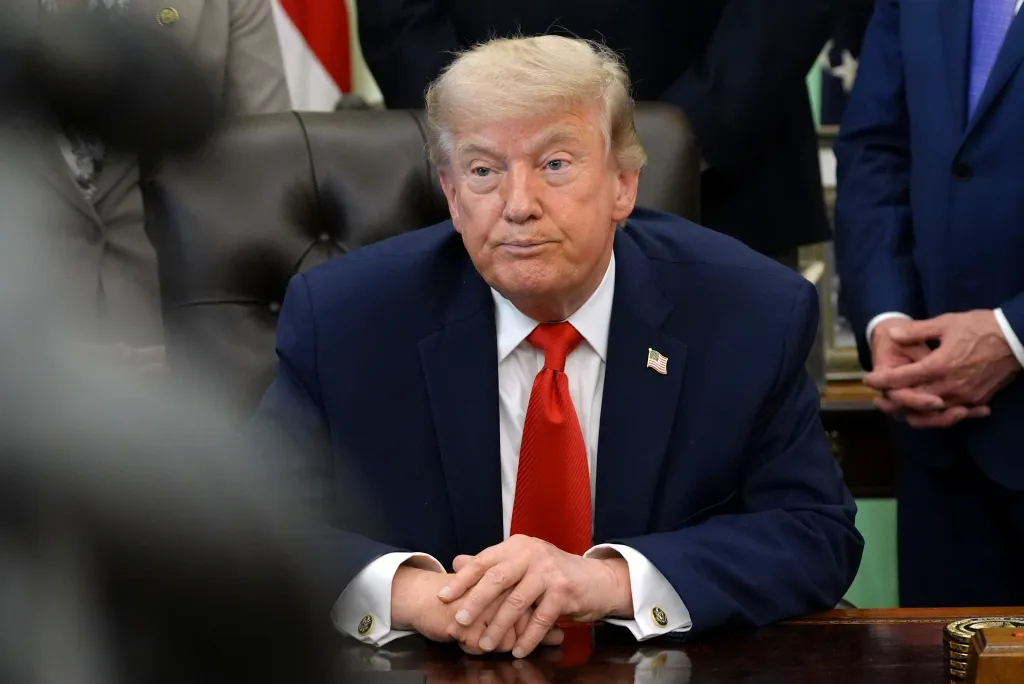 President Donald Trump listening during an event in the Oval Office.