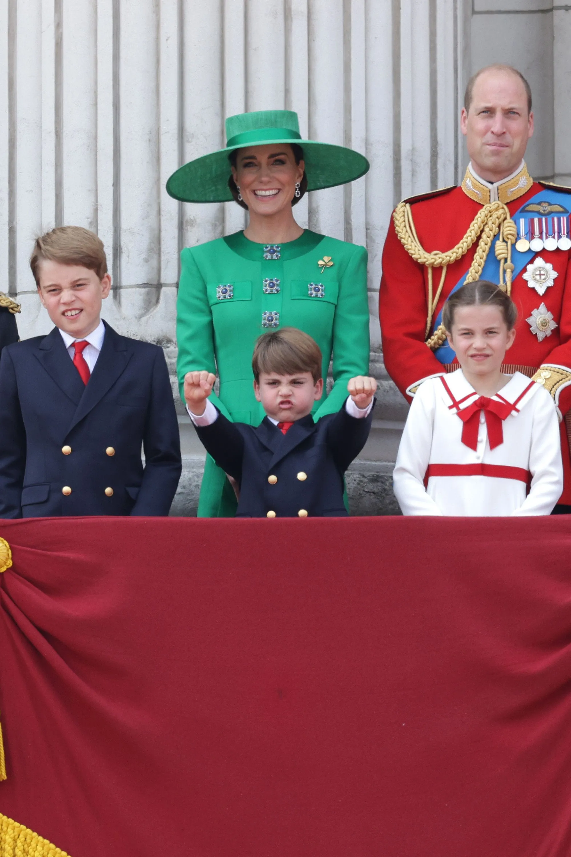 The Princess of Wales, Catherine, Prince George, Prince Louis, Princess Charlotte, and Prince William on the balcony of Buckingham Palace.