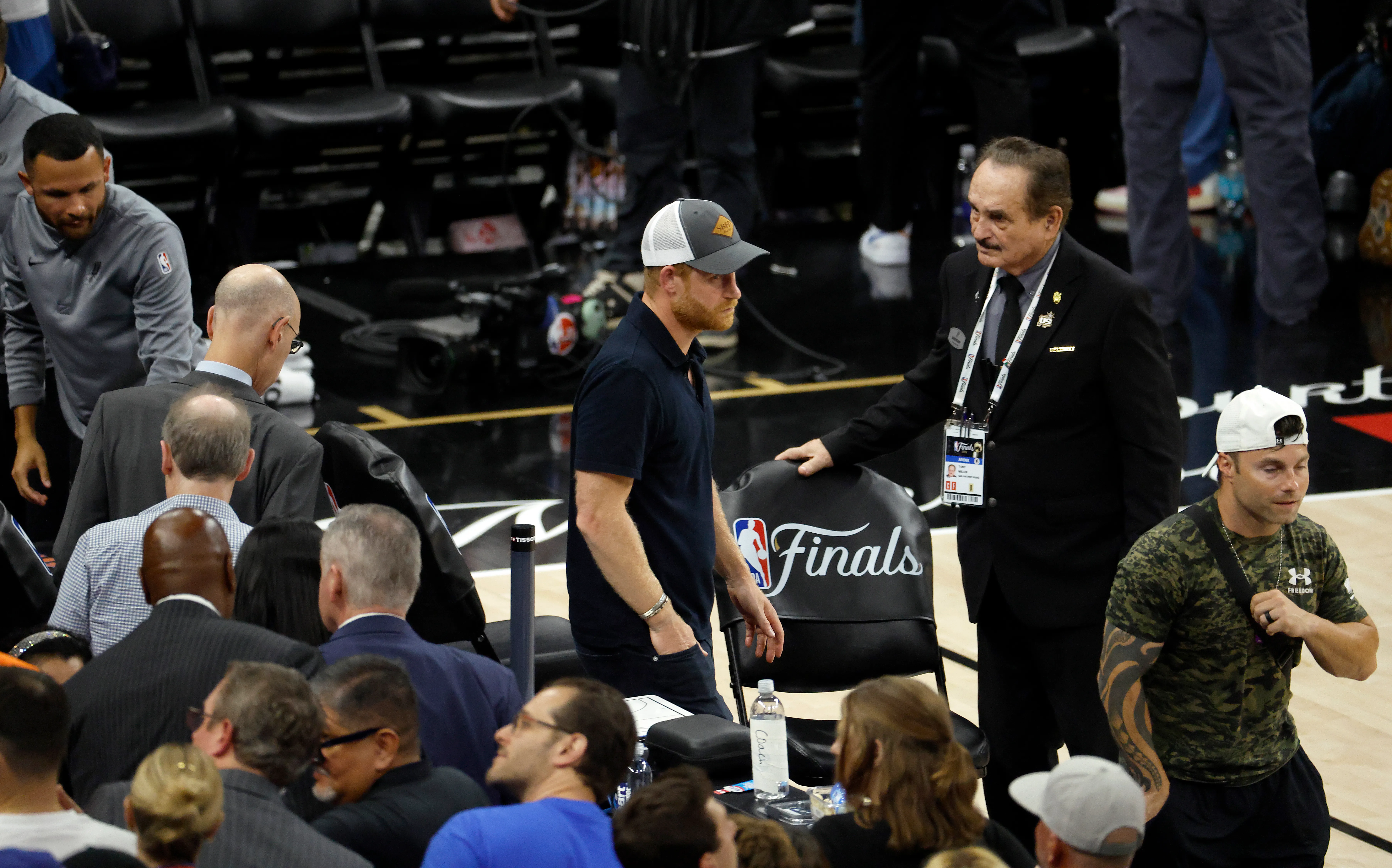 Prince Harry and Adam Silver, Commissioner of the NBA, walk across the court during Game 5 of the 2026 NBA Finals.