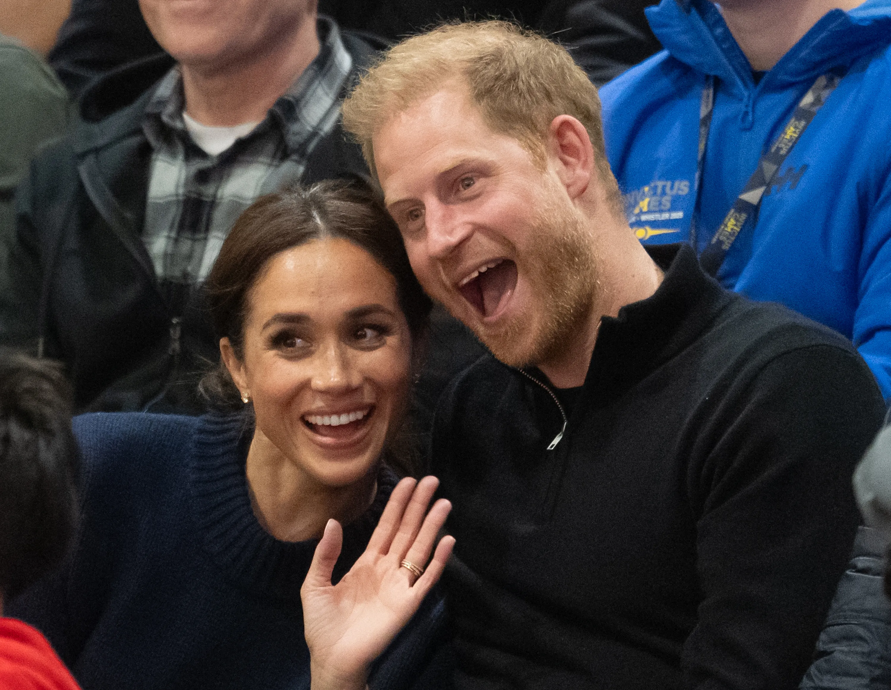 Prince Harry and Meghan Markle smiling at the Invictus Games.