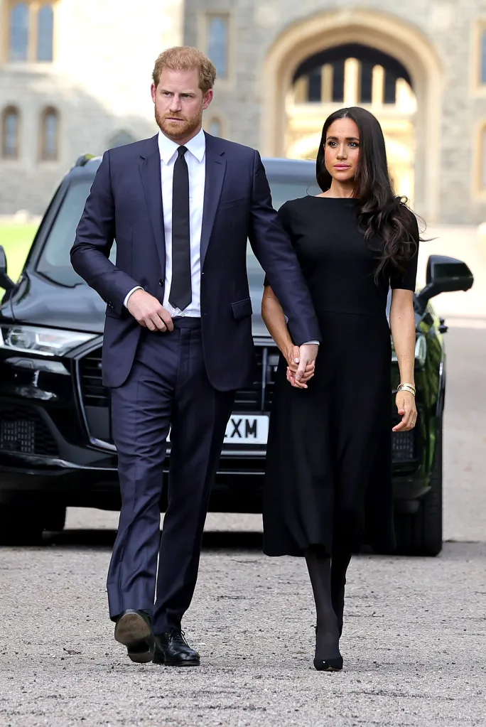 Prince Harry and Meghan Markle holding hands while walking outside Windsor Castle.