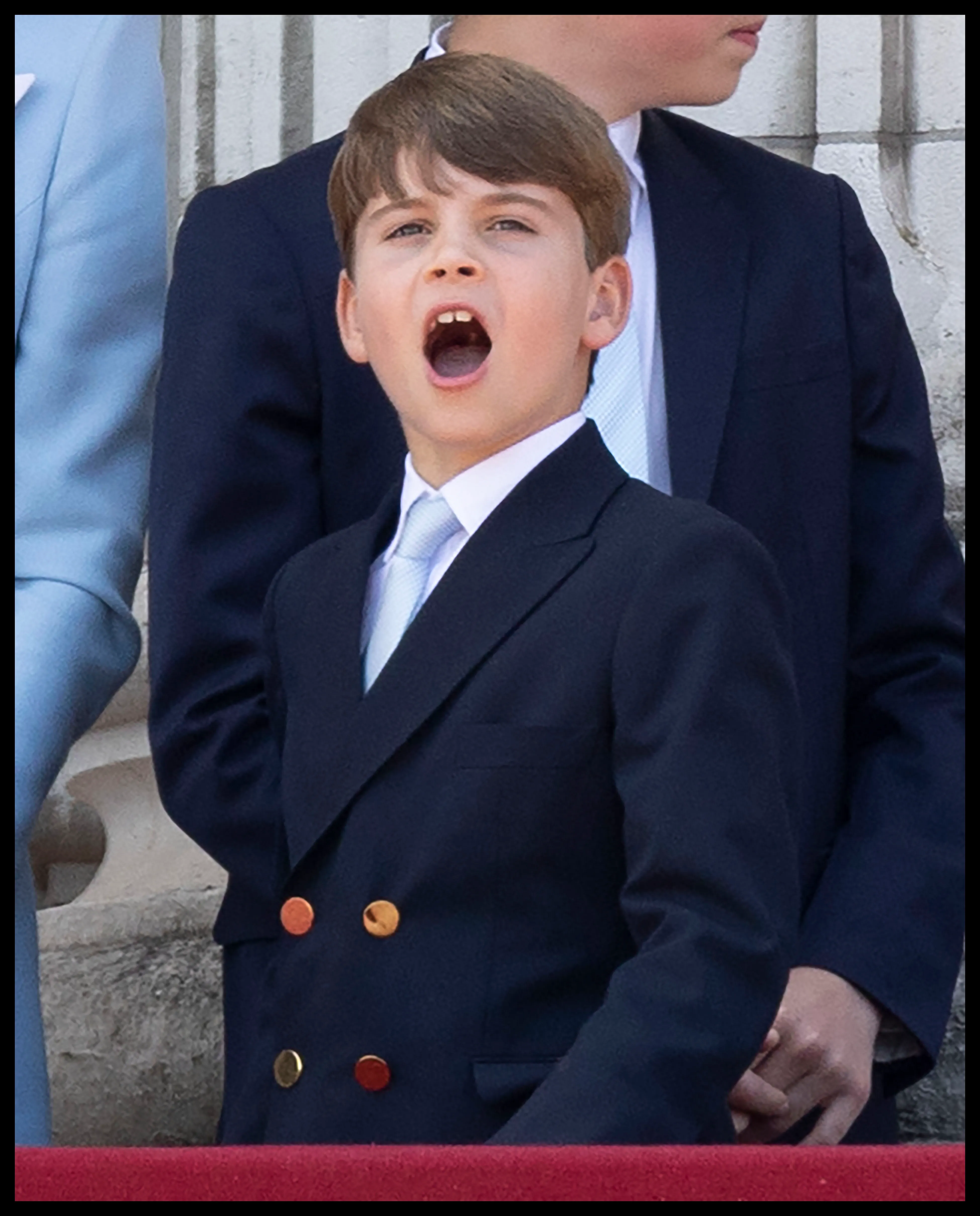 Prince Louis yawning on the balcony of Buckingham Palace.