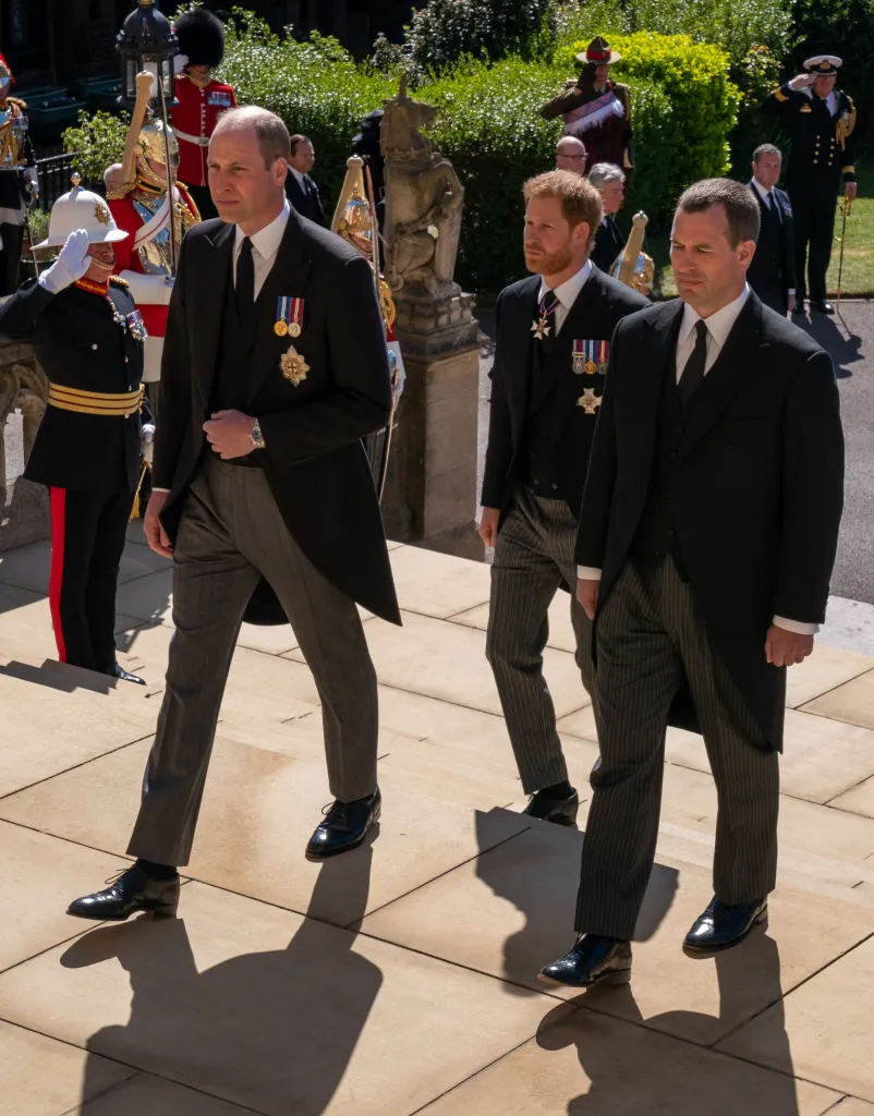 Prince William, Peter Phillips, and Prince Harry follow the Duke of Edinburgh's coffin.