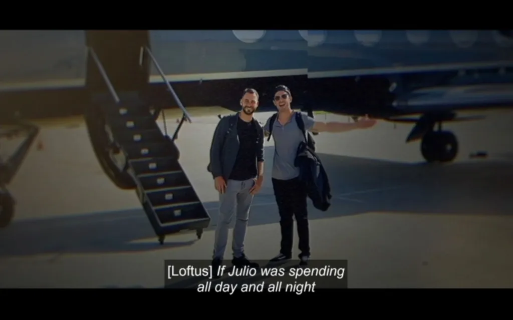 Two men standing in front of a private jet with its stairs extended.