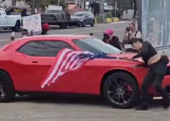 Anti-ICE protester hit by car while waving upside-down US flag outside Delaney Hall