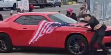 Anti-ICE protester hit by car while waving upside-down US flag outside Delaney Hall