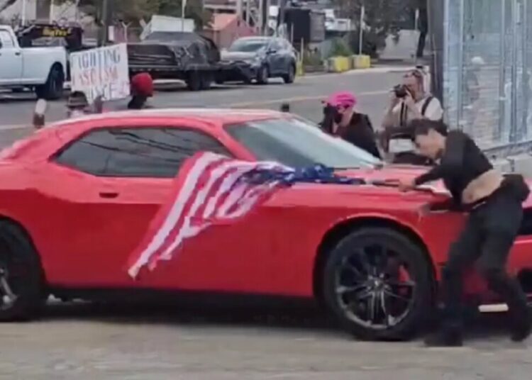 Anti-ICE protester hit by car while waving upside-down US flag outside Delaney Hall