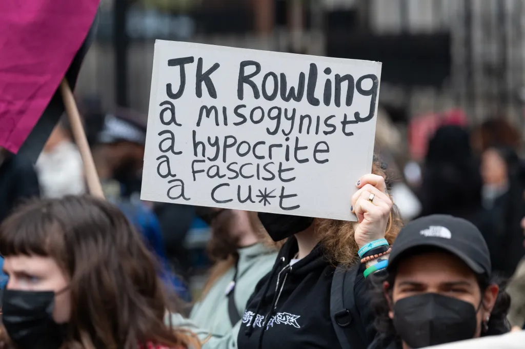 A protester holds a placard reading 