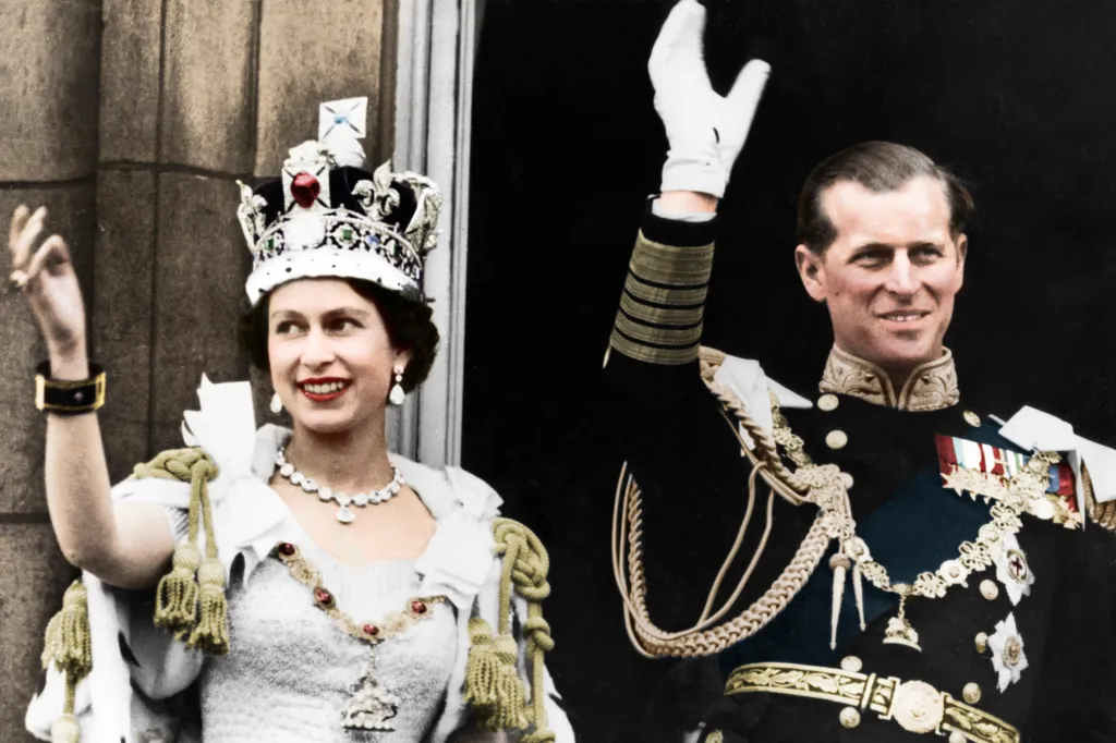 Queen Elizabeth II and the Duke of Edinburgh waving on their coronation day.