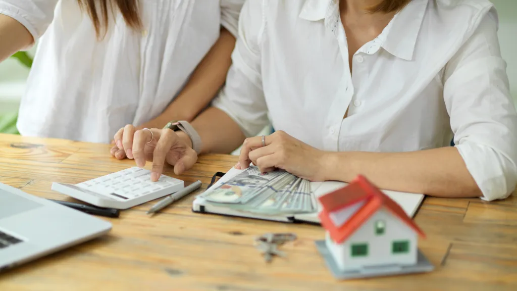 A real estate agent calculates the buyer's down payment.