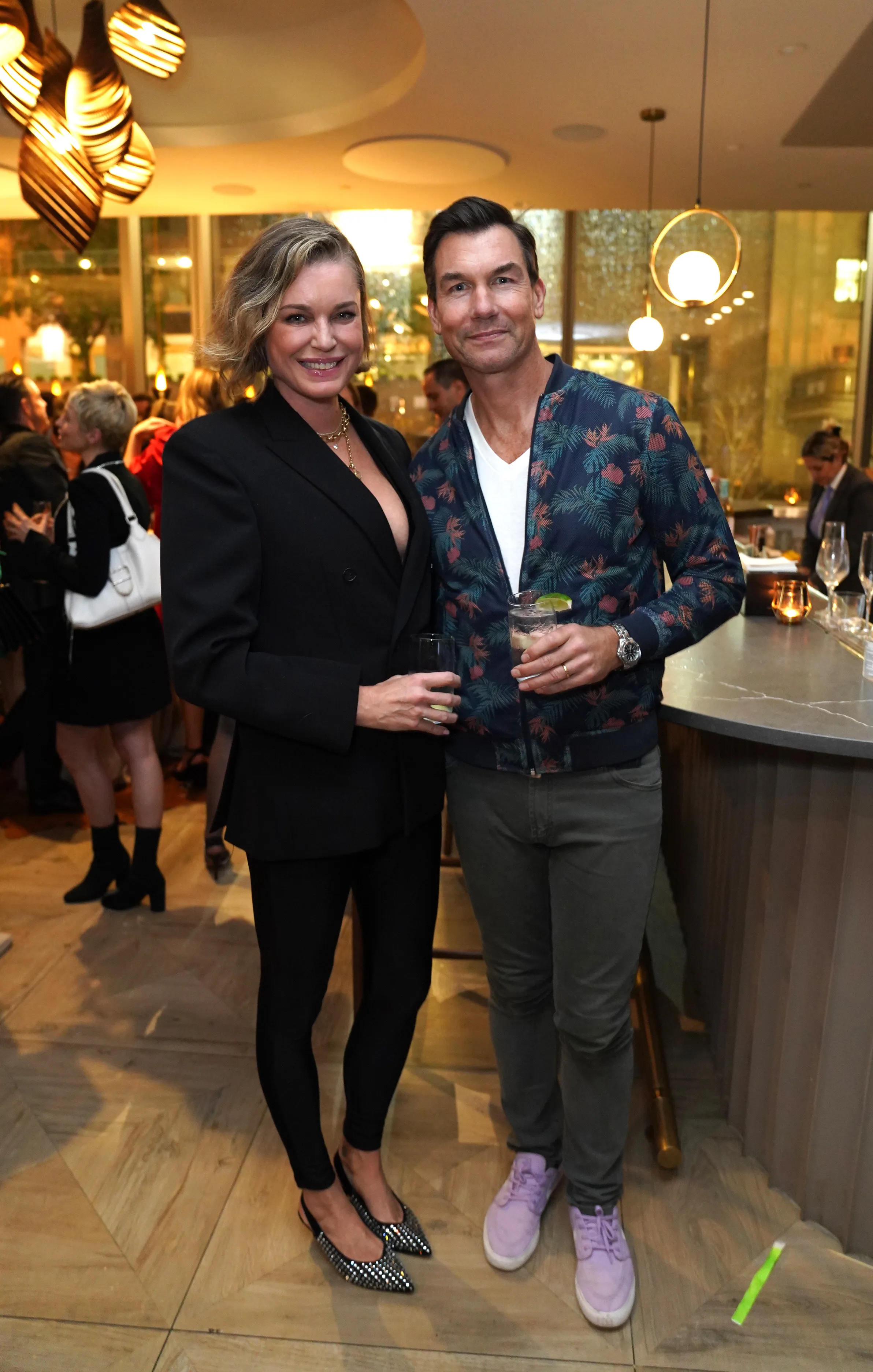 Rebecca Romijn and Jerry O'Connell pose for a photo at a party.