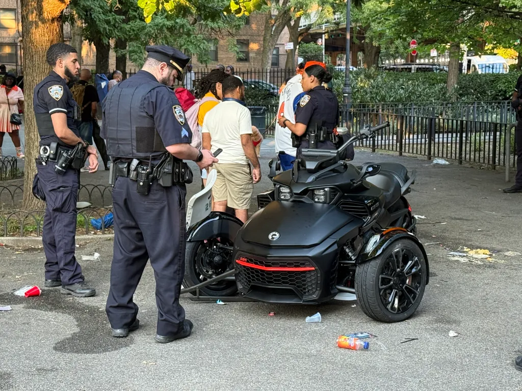 Police officers investigating a three-wheeled scooter after it reportedly struck several pedestrians in a park.