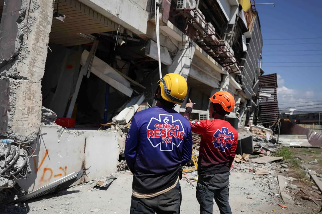Rescuers inspect a damaged building following an earhtquake in General Santos, Philippines Tuesday, June 9, 2026.