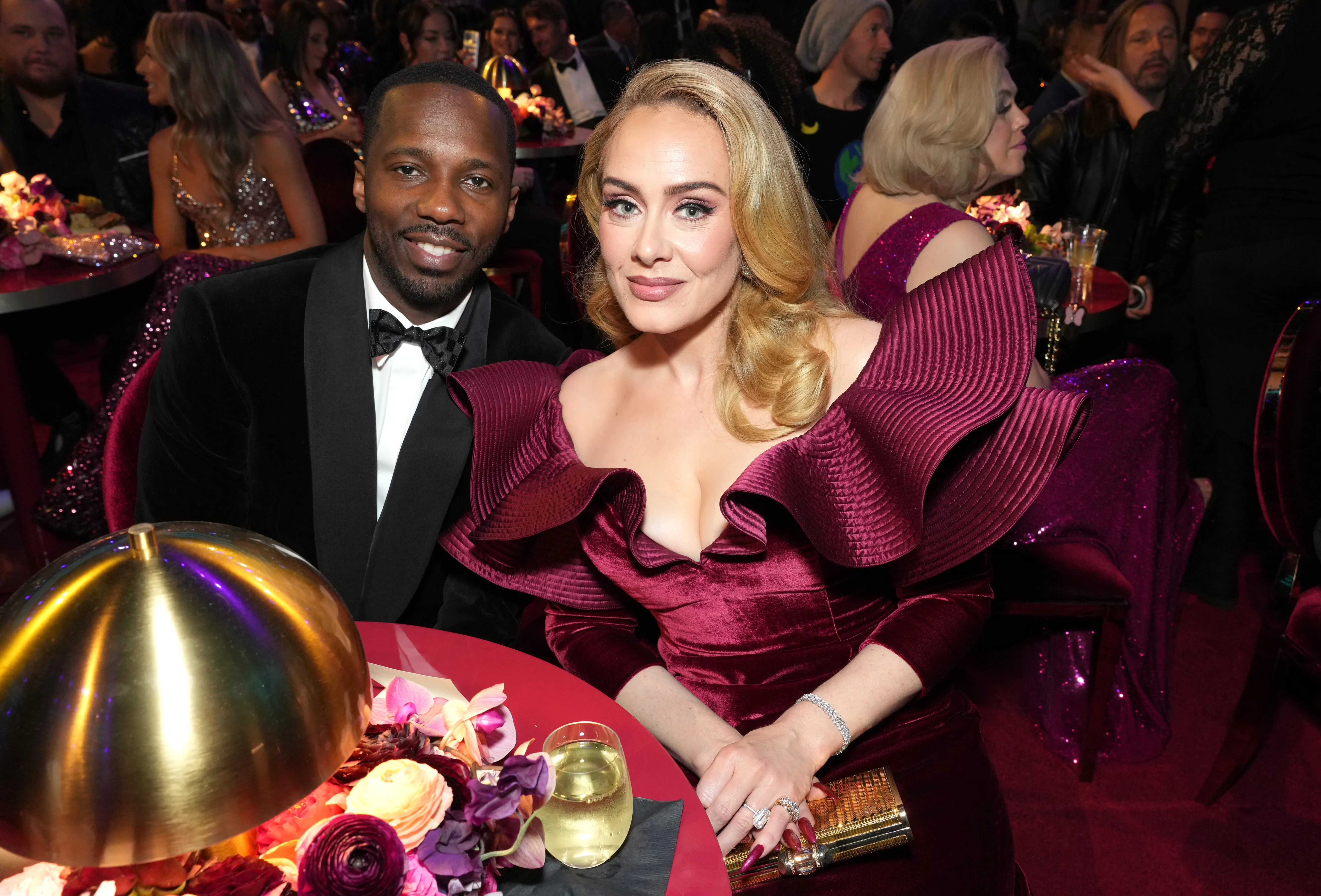 Rich Paul and Adele smiling at the 65th GRAMMY Awards.