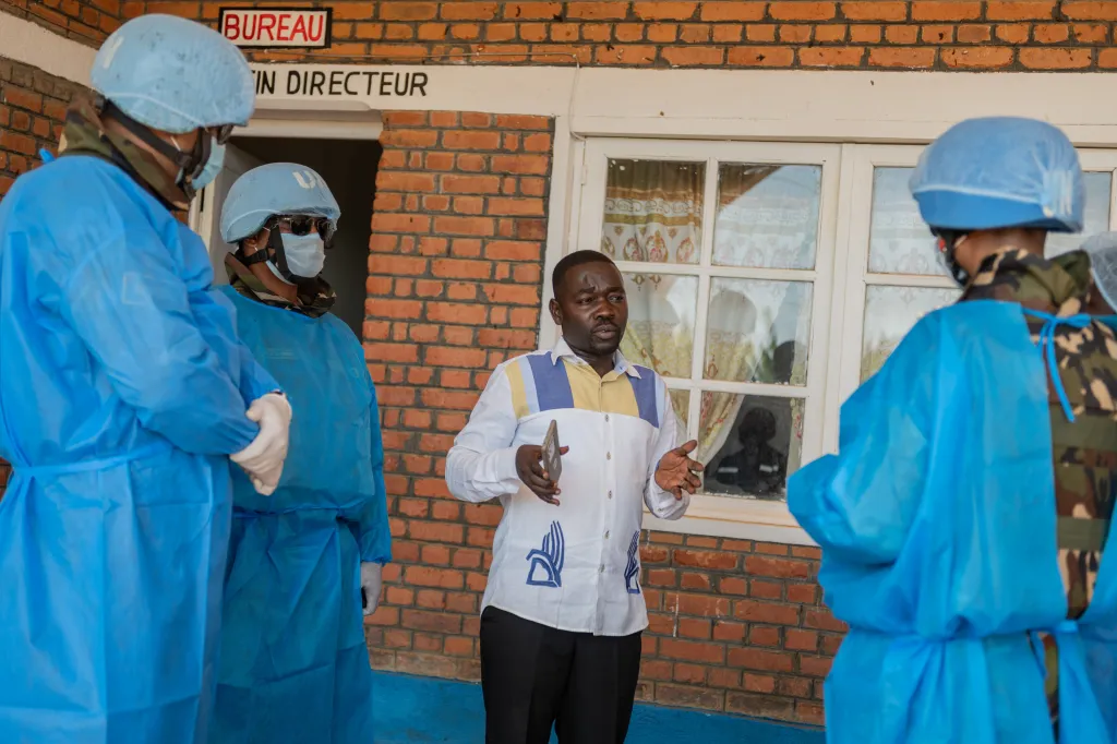 Richard Lokudu, medical director of Mongbwalu General Hospital, speaks with UN peacekeepers.