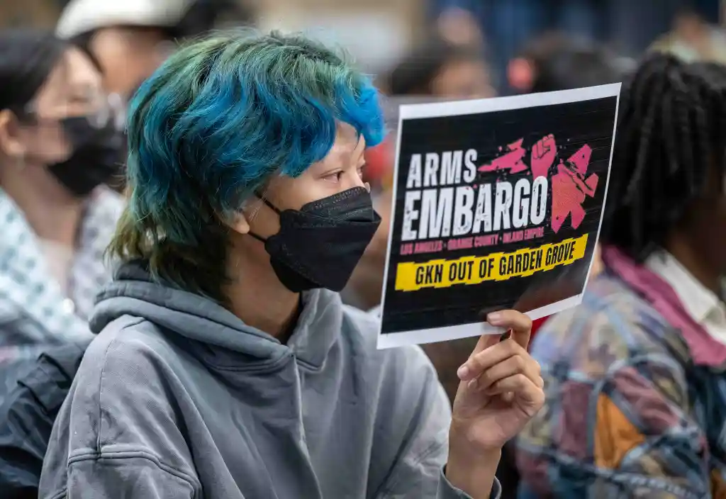 Rose Khau of Garden Grove holding a sign that reads 