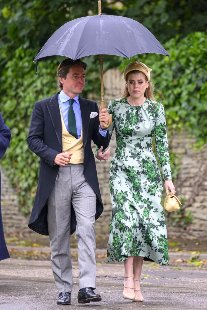 Princess Beatrice and Edoardo Mapelli Mozzi walking under an umbrella at the wedding of Peter Phillips and Harriet Sperling.