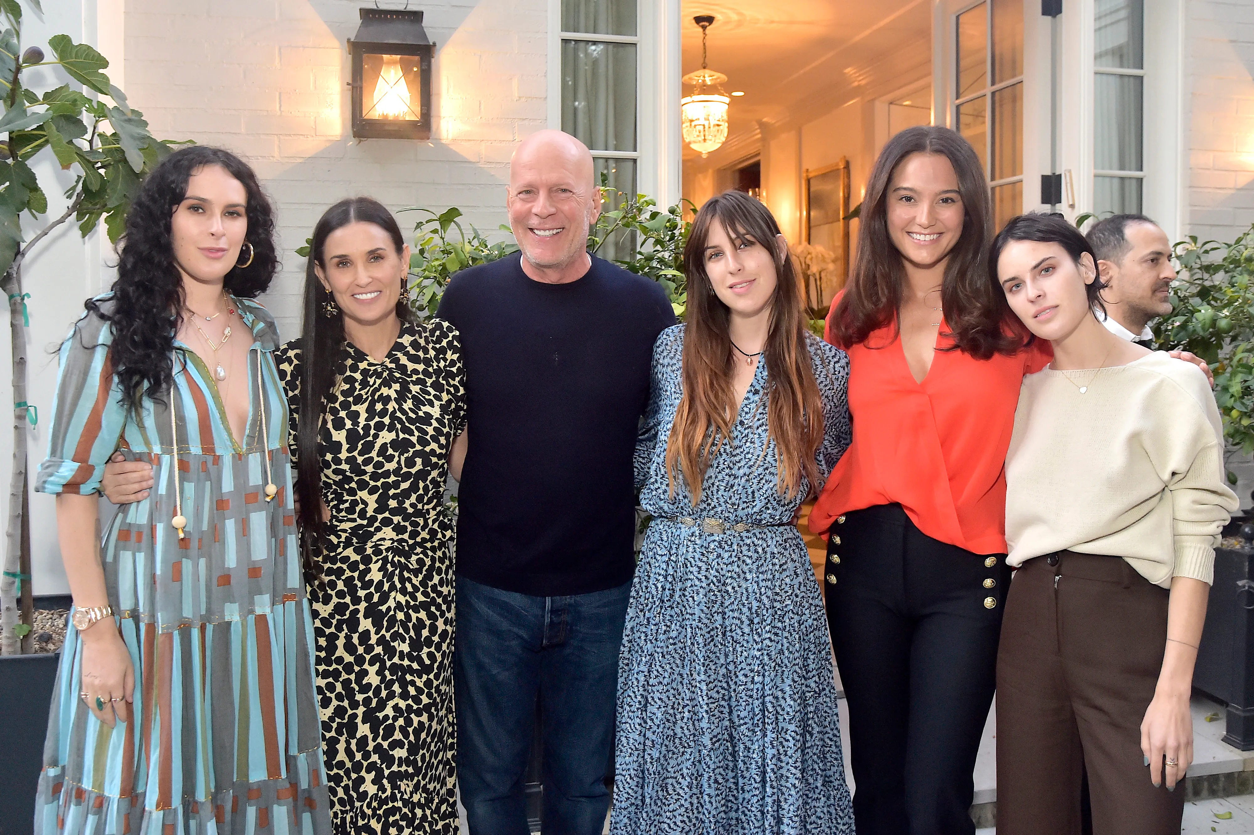 Rumer Willis, Demi Moore, Bruce Willis, Scout Willis, Emma Heming Willis, and Tallulah Willis posing together at a book party.
