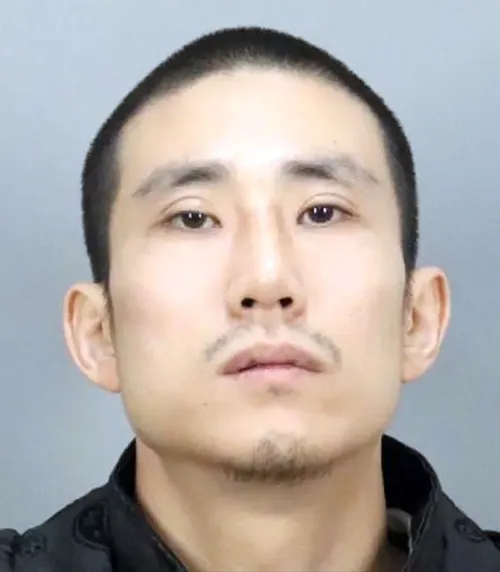 Mugshot of Myung Jin Kim, a California fugitive wanted in connection with two murders.