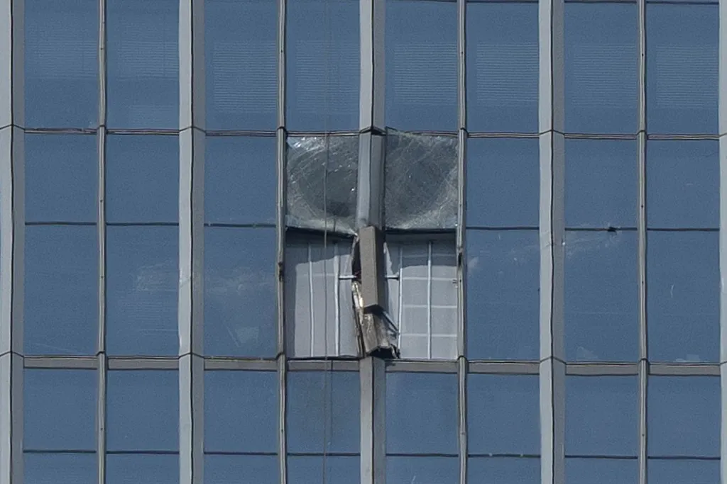 The section of the skyscraper damaged by the plane crash is boarded up at the CITIC Tower.