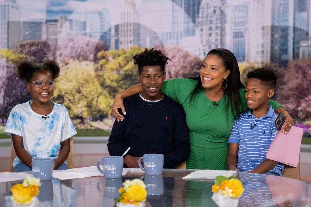 Sheinelle Jones, in a green dress, with her kids Clara, in a blue and white T-shirt, Kayin, in black sweater, and Uche Jr, in a blue and white striped T-shirt, during Take Your Child To Work Day.