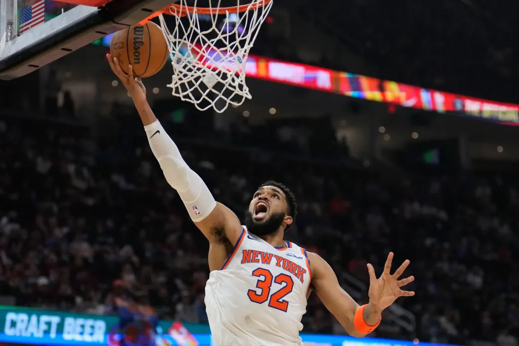 Karl-Anthony Towns (32) shooting a basketball during an NBA game.